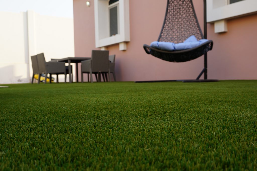 Perforated artificial grass